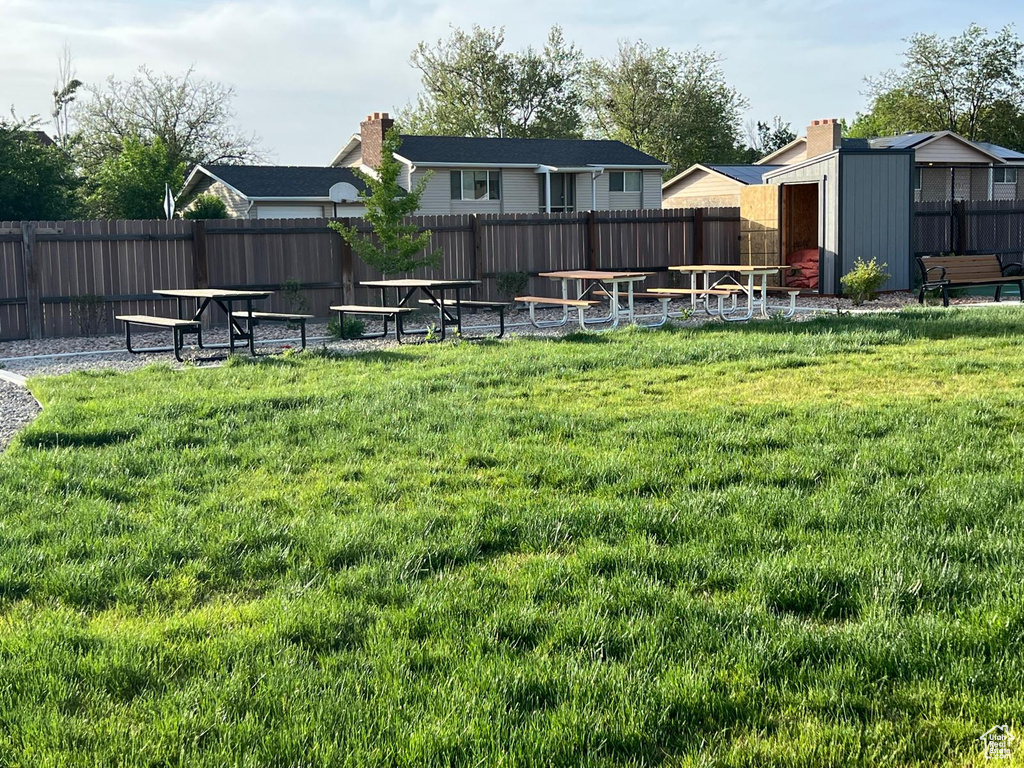 View of yard with a storage unit and an outbuilding