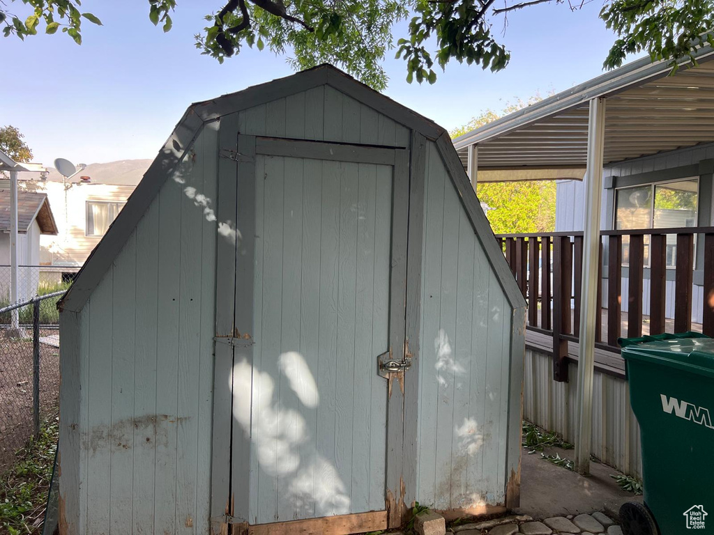View of shed featuring fence