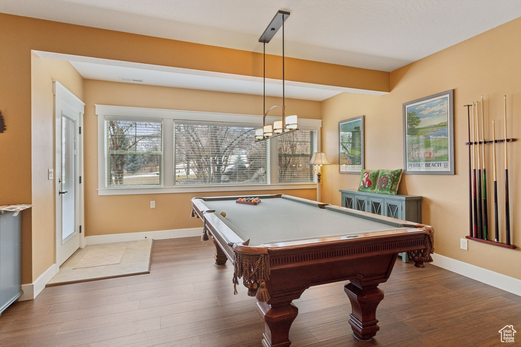Recreation room featuring wood finished floors, baseboards, and pool table