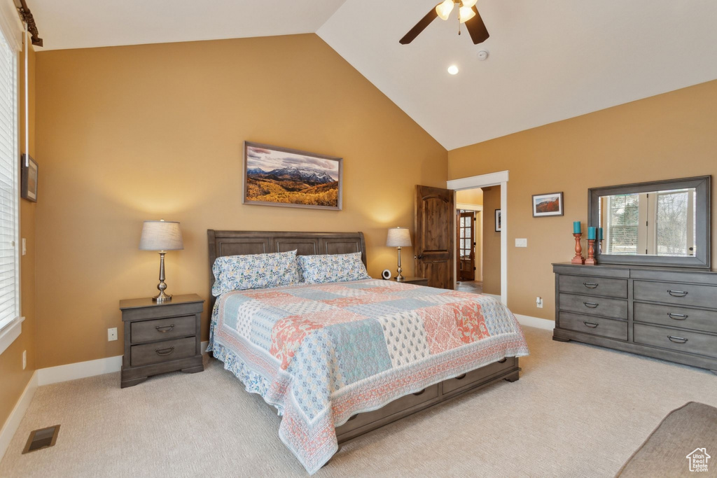 Carpeted bedroom with baseboards, high vaulted ceiling, and a ceiling fan