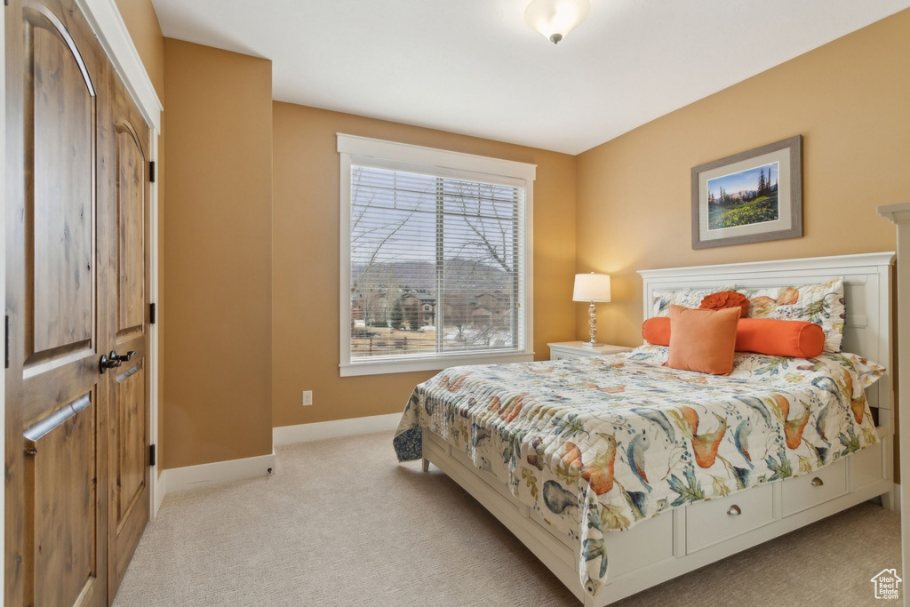 Bedroom with carpet floors and baseboards