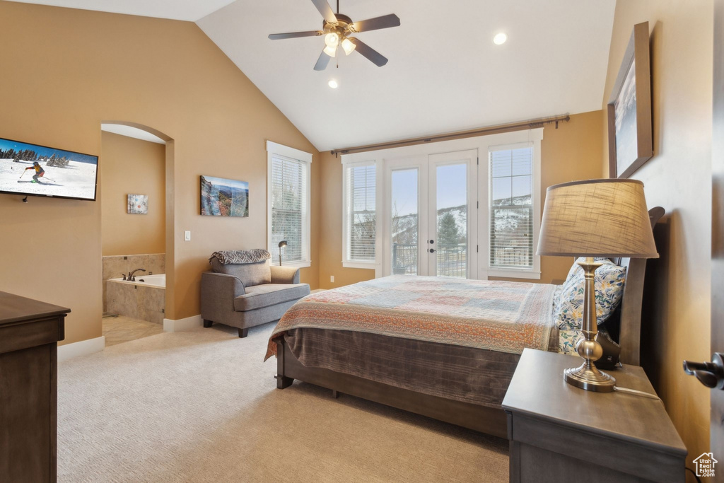 Bedroom featuring light carpet, vaulted ceiling, recessed lighting, ensuite bath, and french doors