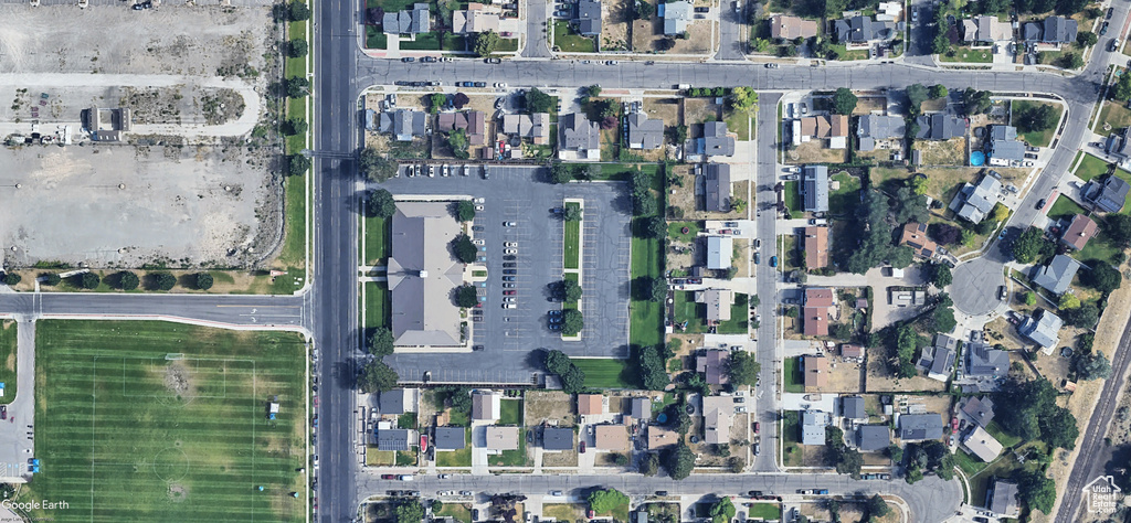 Aerial view of property\'s location featuring nearby suburban area