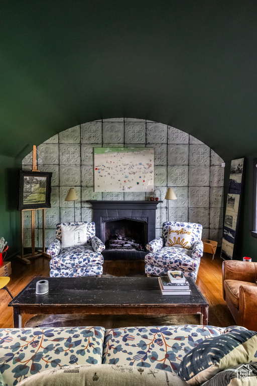 Living room featuring wood finished floors and a tile fireplace