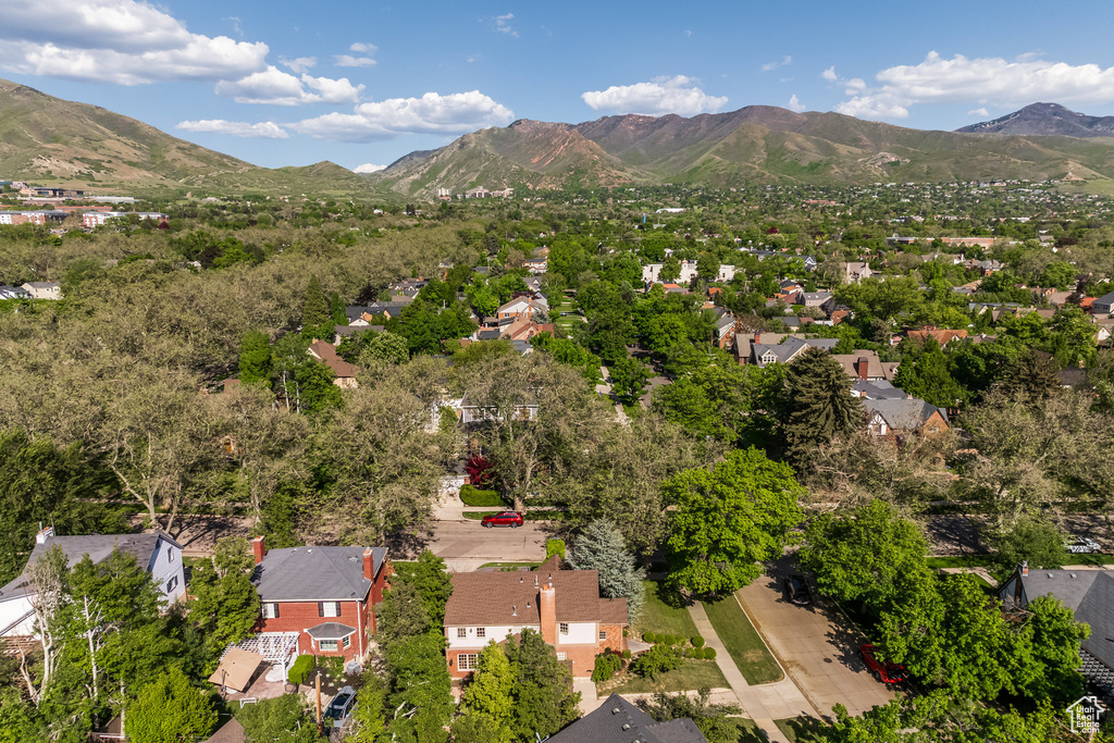 Aerial view of property's location with a mountain backdrop and nearby suburban area