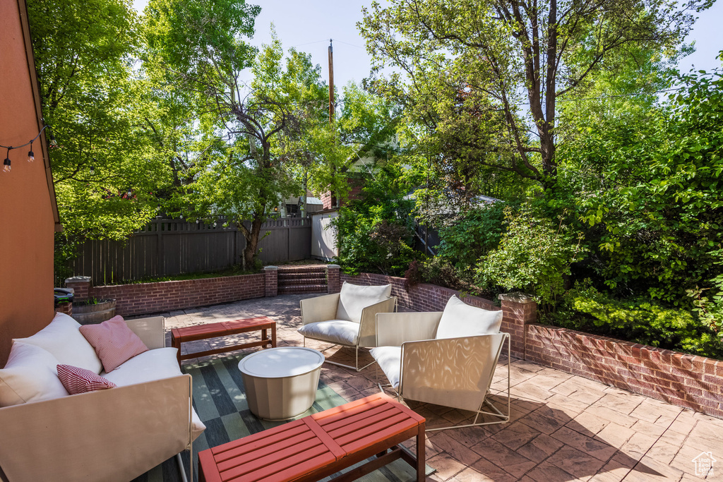 View of patio / terrace featuring outdoor lounge area and fence
