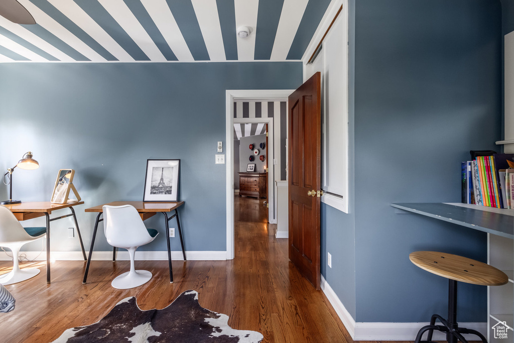 Office space with wood finished floors and baseboards