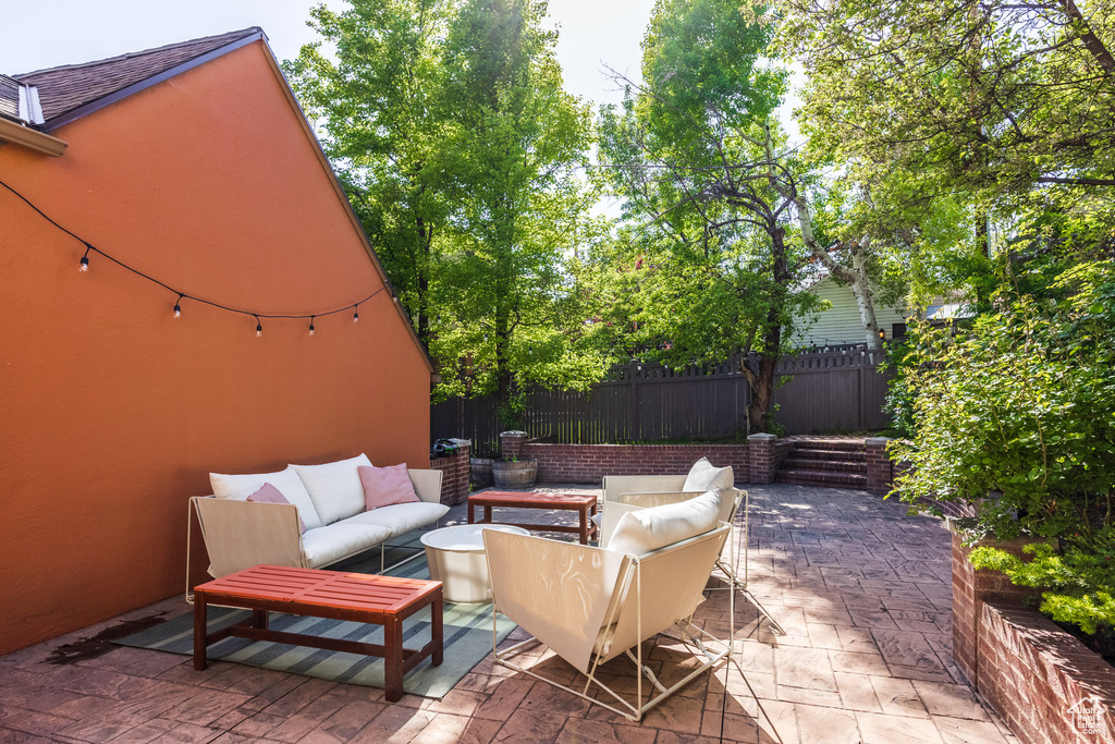 View of patio / terrace featuring an outdoor hangout area and fence