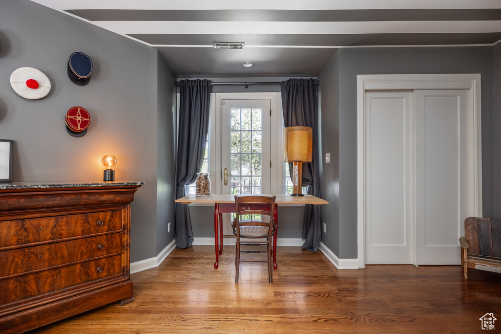 Office with wood finished floors and baseboards