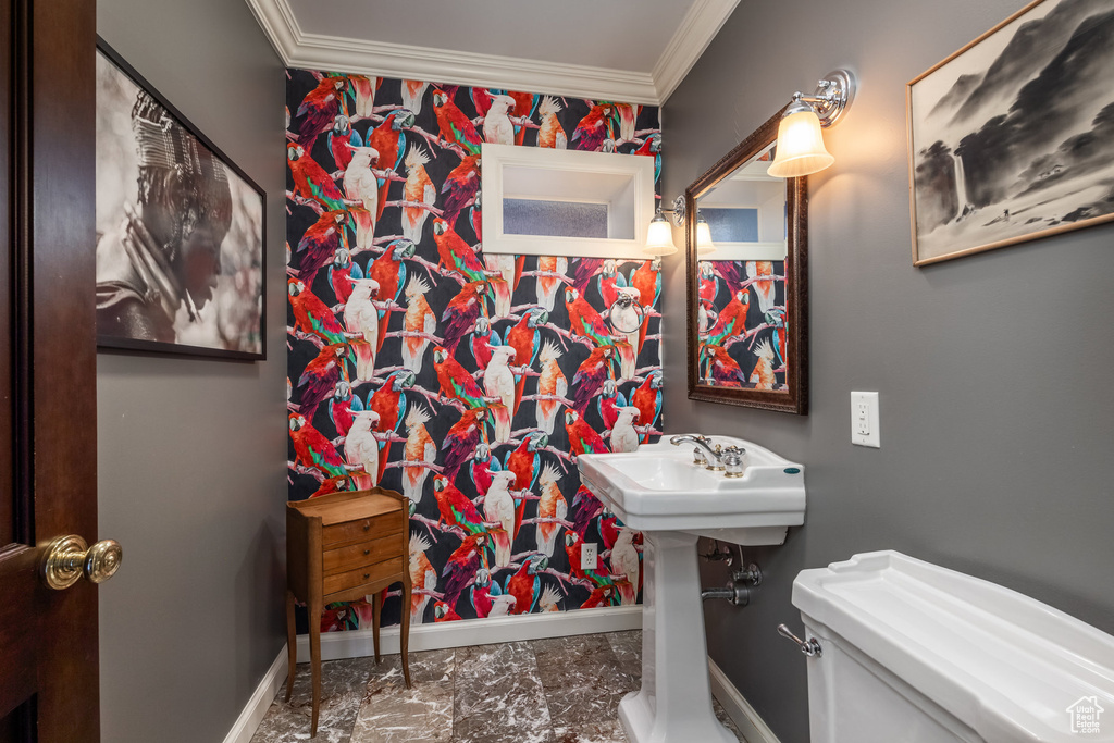 Bathroom with crown molding, baseboards, marble finish flooring, and toilet