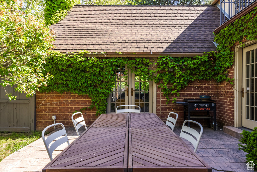 View of patio with outdoor dining area and french doors