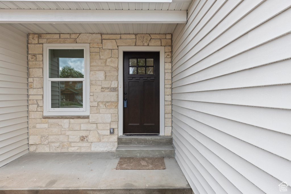 Entrance to property with stone siding