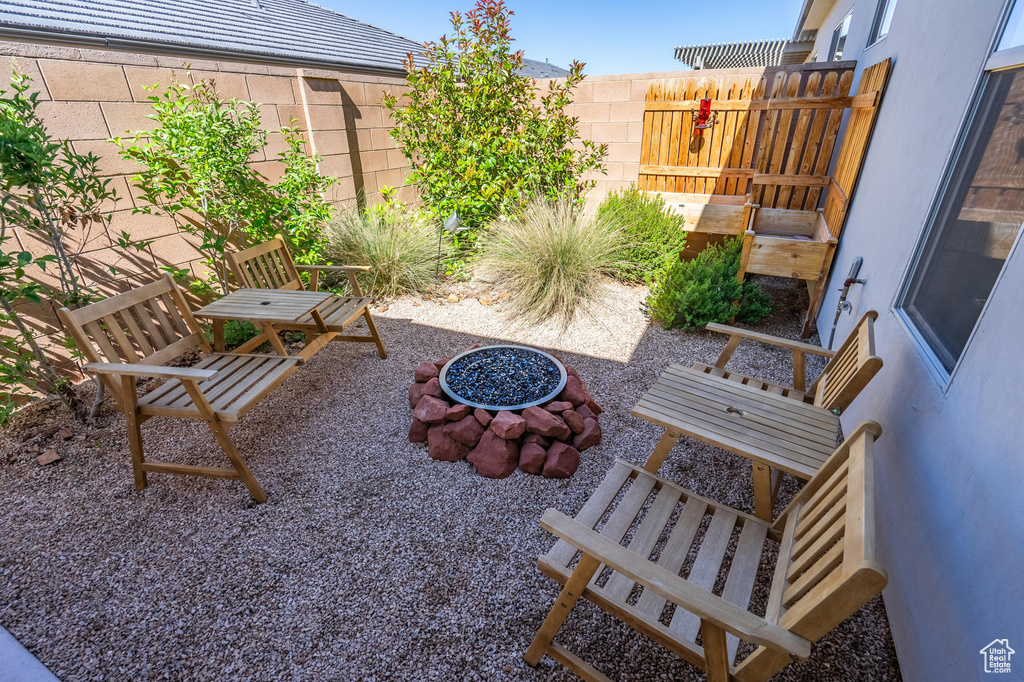 View of patio / terrace with fence and a fire pit