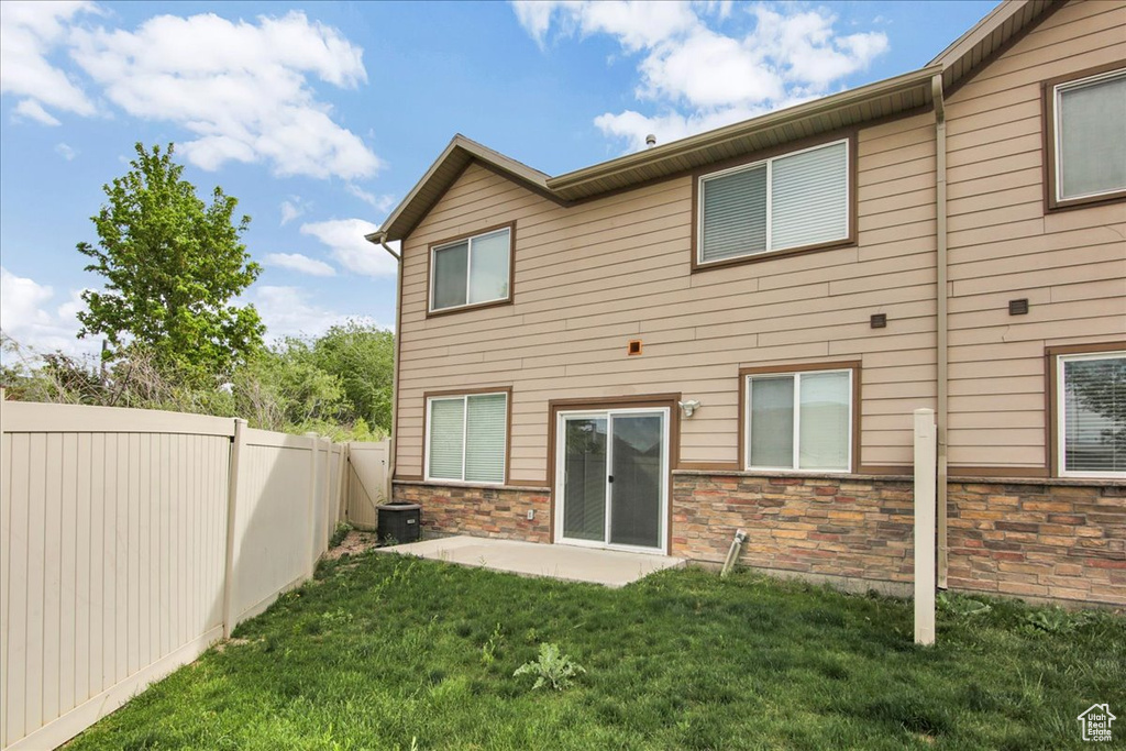 Rear view of property with a patio and stone siding