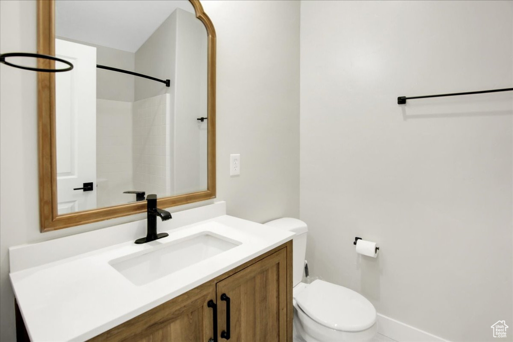 Full bath featuring toilet and vanity