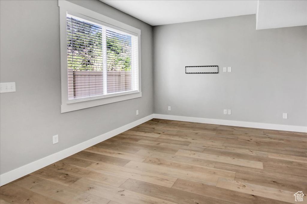 Spare room featuring wood finished floors and baseboards