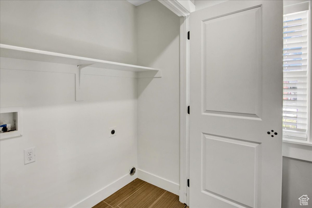 Laundry room featuring baseboards, hookup for an electric dryer, dark wood-style flooring, and hookup for a washing machine