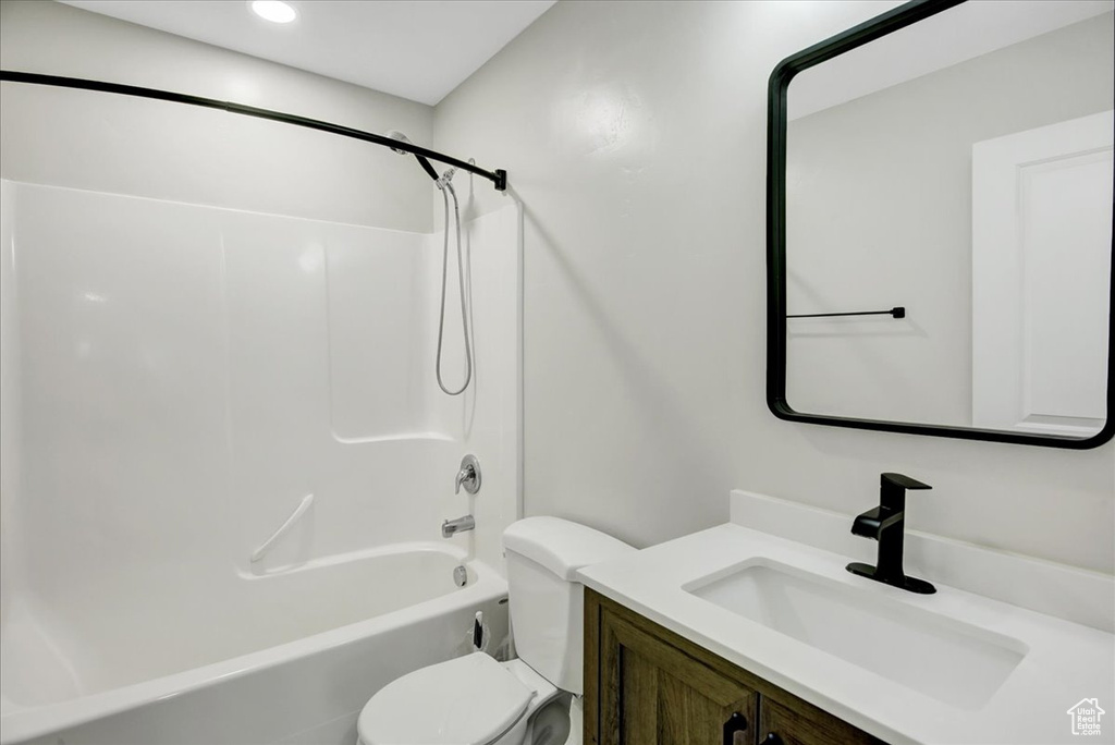 Full bathroom with toilet, vanity, bathing tub / shower combination, and recessed lighting