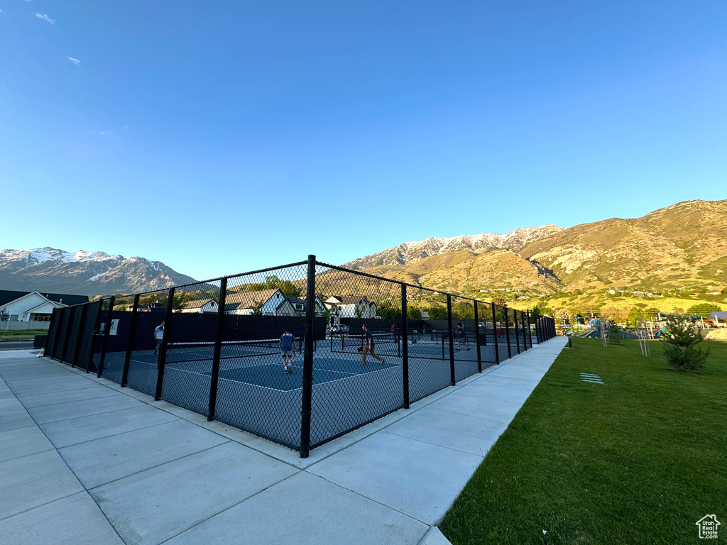 View of community featuring a tennis court and a mountain view