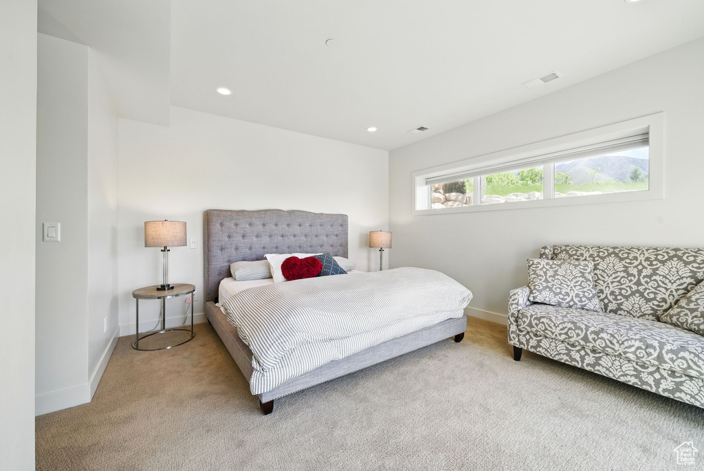 Carpeted bedroom with baseboards and recessed lighting