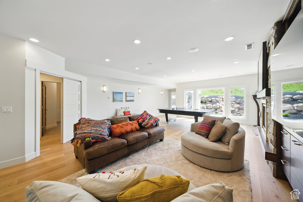 Living area featuring light wood-style floors, recessed lighting, and pool table