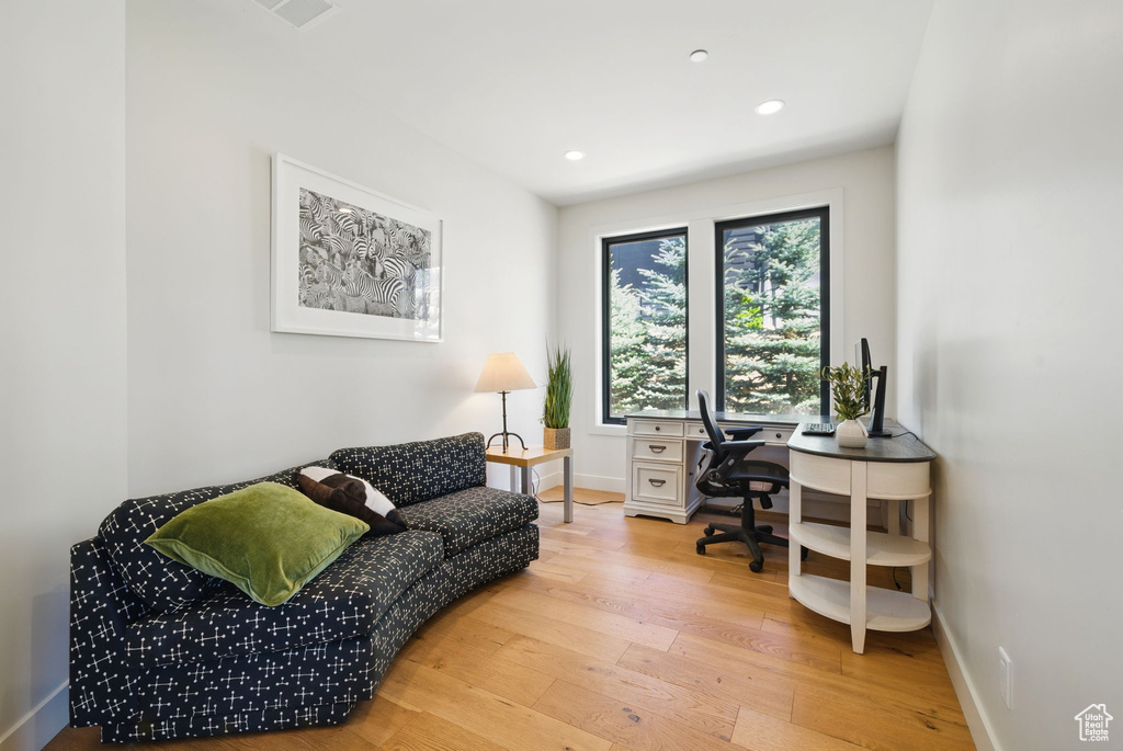 Office space with hardwood / wood-style flooring, recessed lighting, and baseboards