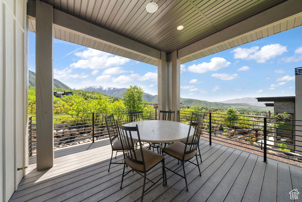Wooden terrace with a mountain view and outdoor dining area