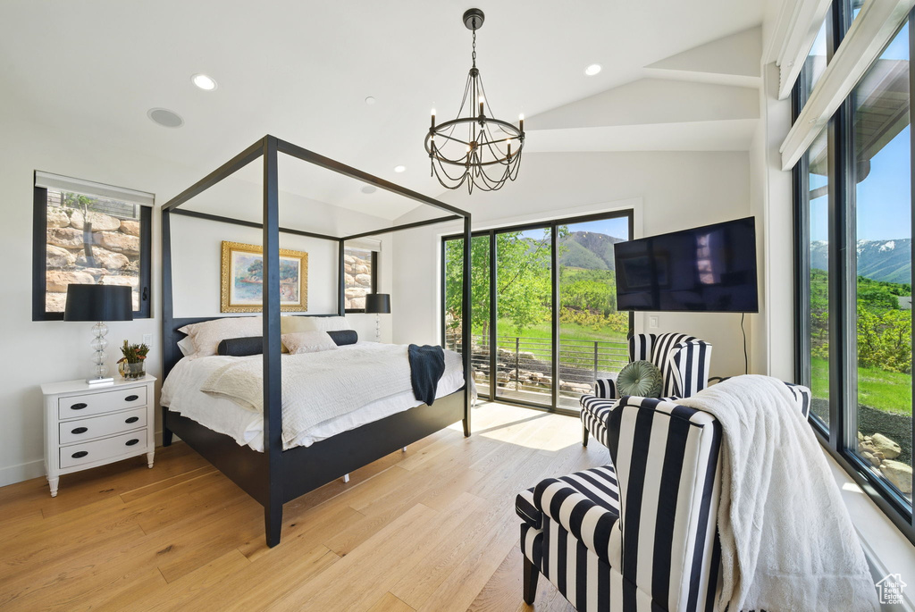 Bedroom with access to exterior, a chandelier, high vaulted ceiling, light wood-style floors, and recessed lighting