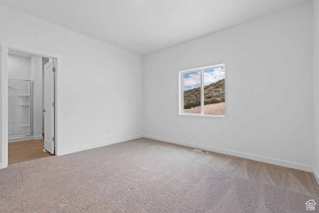 Unfurnished bedroom featuring carpet floors and baseboards