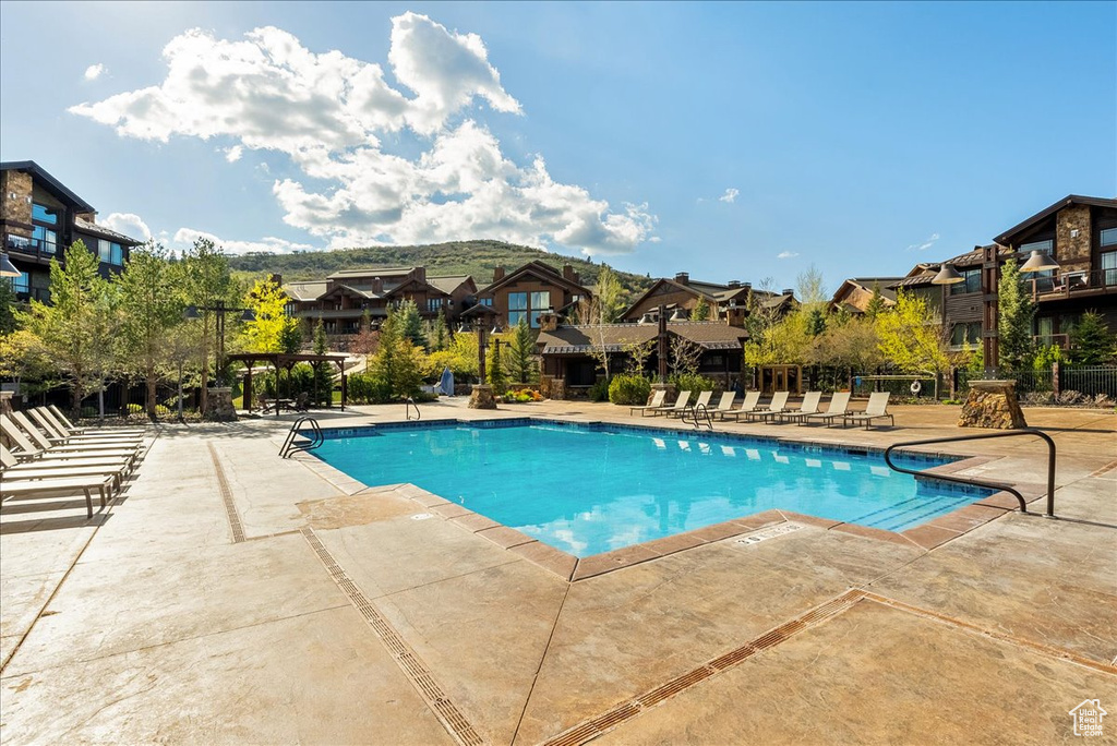 Community pool featuring a residential view and a patio