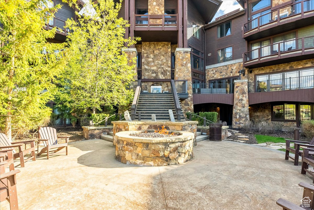 View of community with stairs, a patio, and a fire pit
