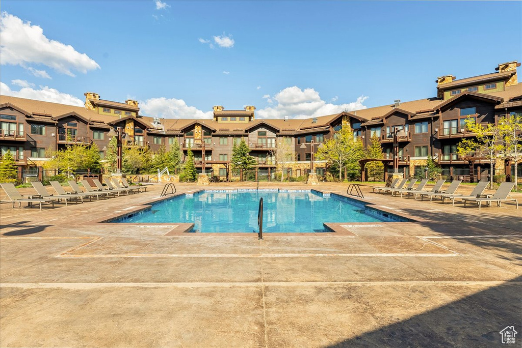 Community pool featuring a residential view and a patio area