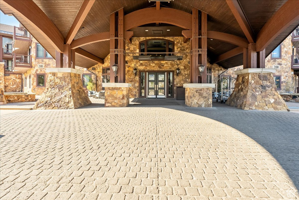 View of exterior entry featuring stone siding and french doors