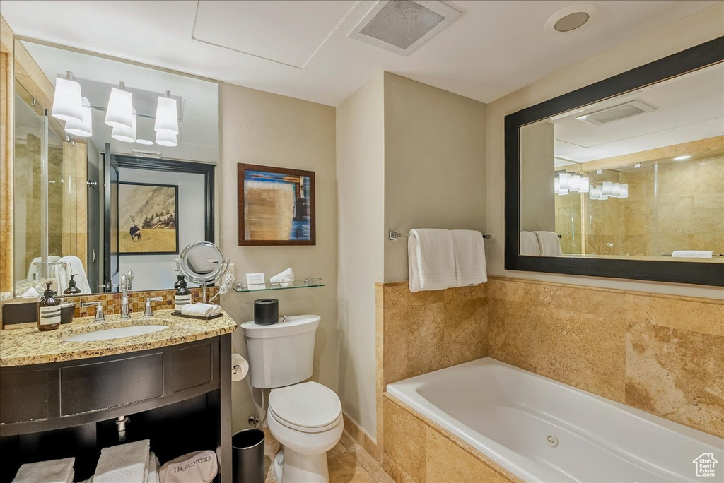 Full bathroom featuring a garden tub, toilet, a tile shower, tile patterned flooring, and vanity