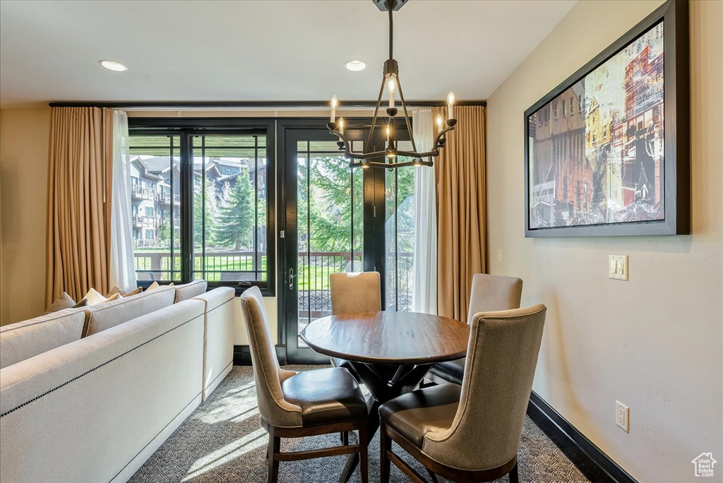 Dining space featuring a chandelier, plenty of natural light, baseboards, and recessed lighting