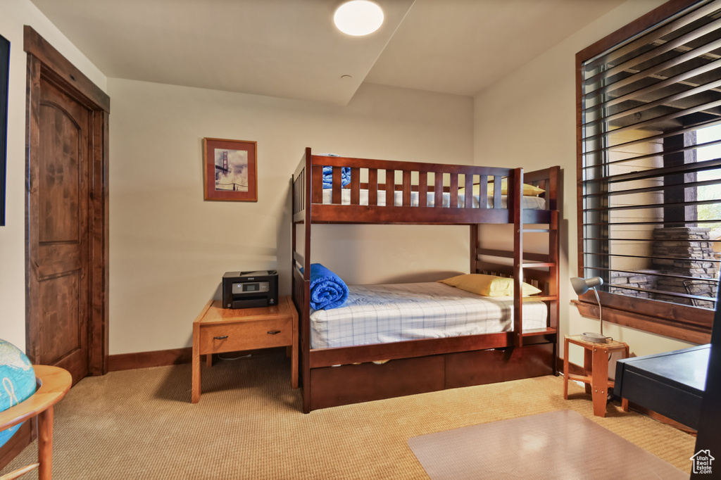 Bedroom featuring carpet and baseboards