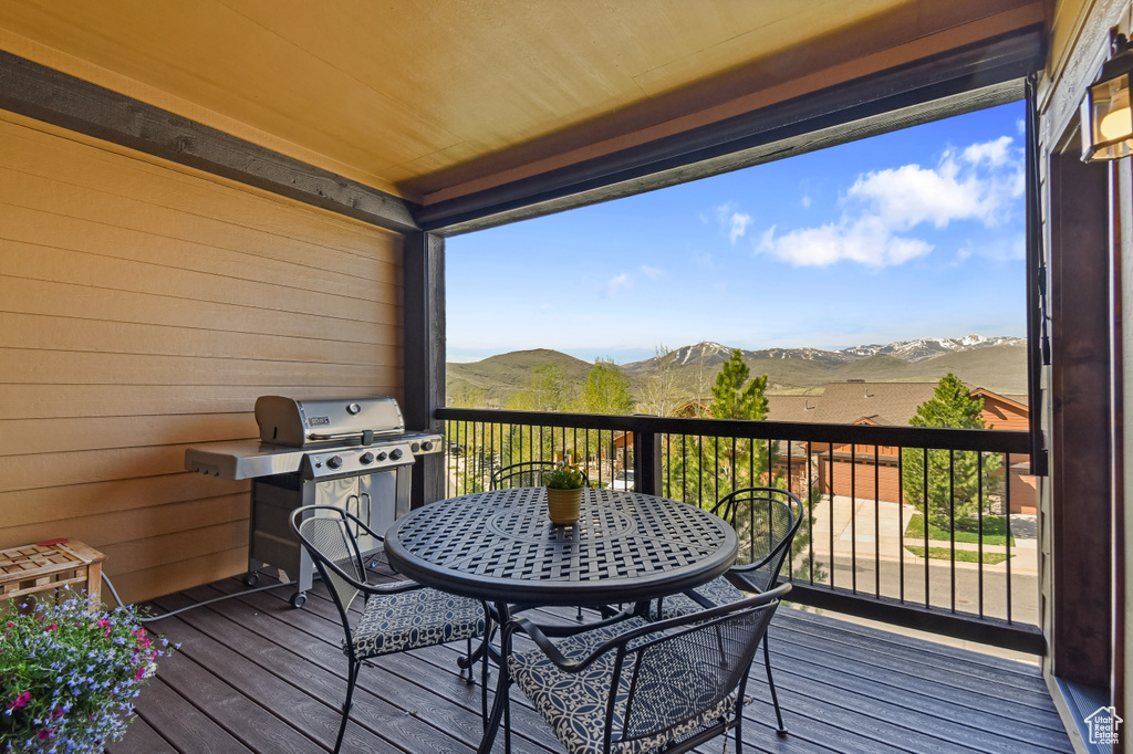 Deck featuring a mountain view and a grill