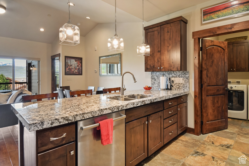 Kitchen featuring washer / clothes dryer, dishwasher, a sink, a peninsula, and decorative light fixtures