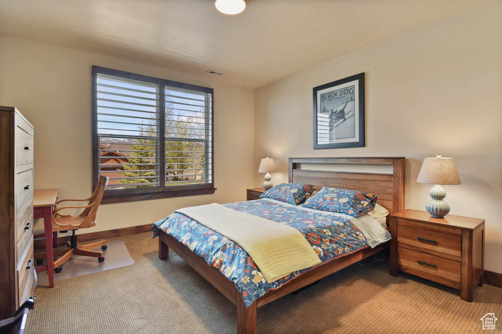 Bedroom with carpet floors, baseboards, and an office area