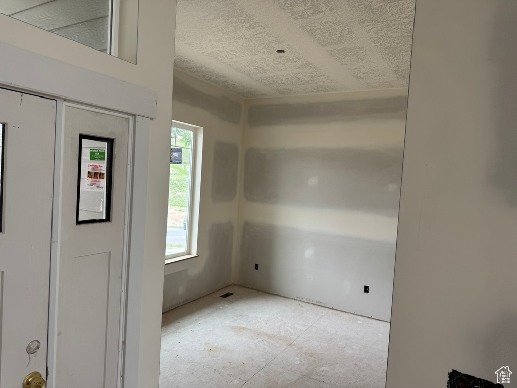 Foyer entrance featuring a textured ceiling