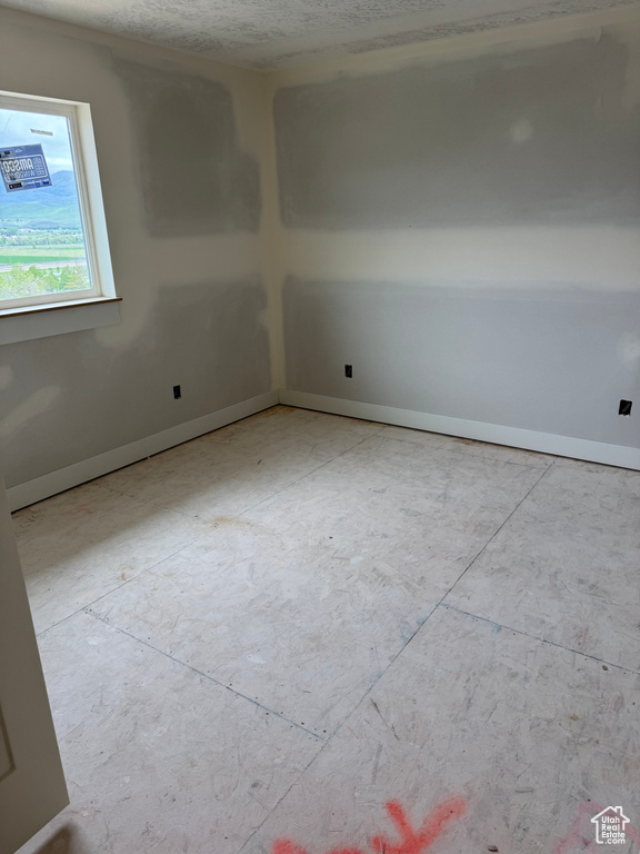 Spare room featuring baseboards