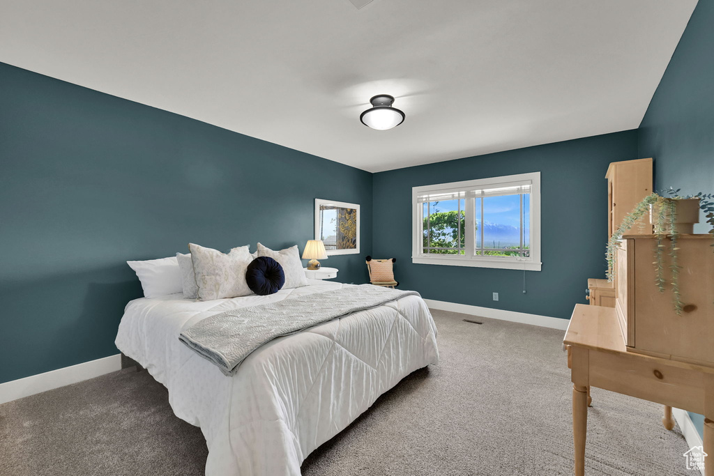 Bedroom featuring baseboards and carpet