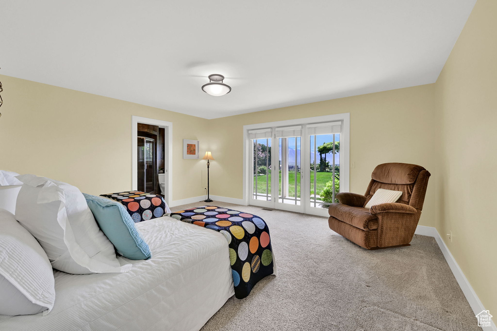 Carpeted bedroom featuring access to exterior and baseboards