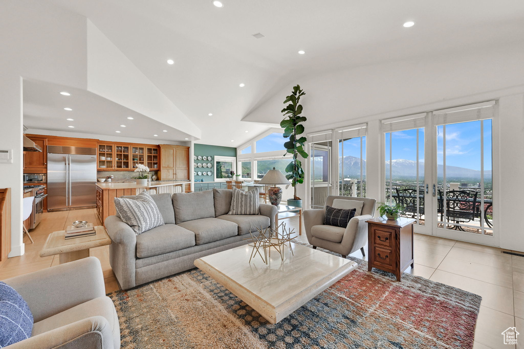 Living room with recessed lighting, lofted ceiling, and light tile patterned floors