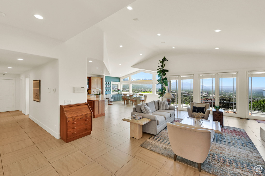 Living area featuring recessed lighting and high vaulted ceiling