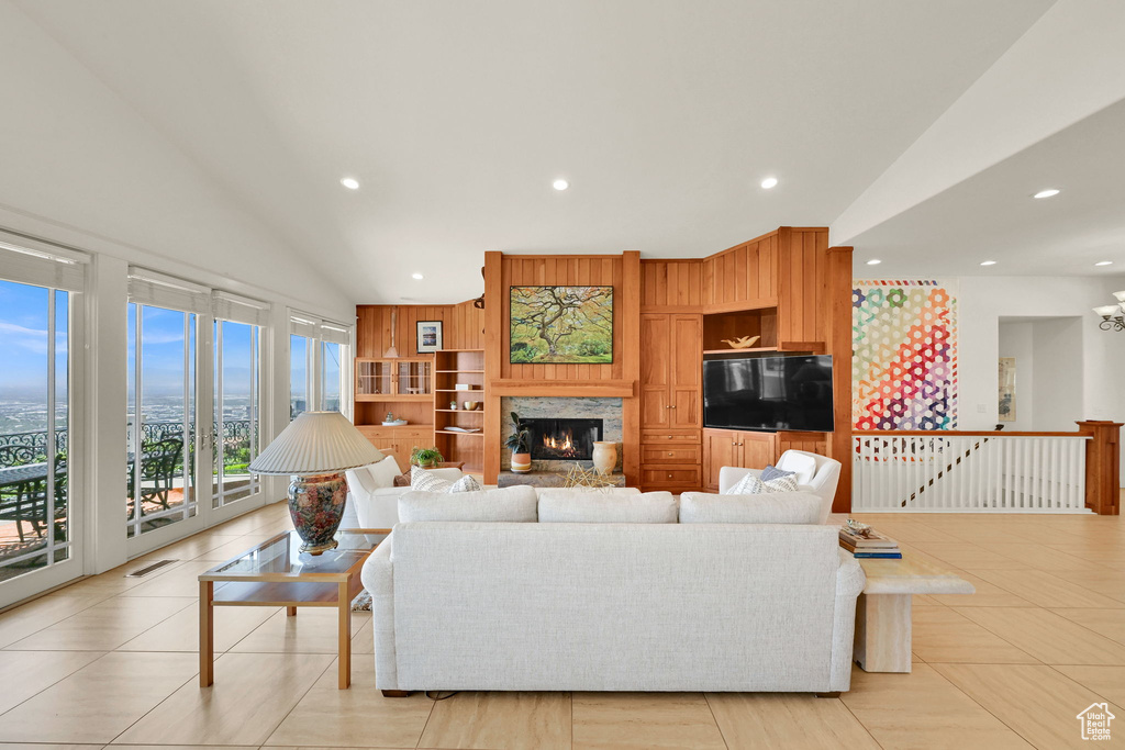 Living room with recessed lighting, a fireplace, and lofted ceiling