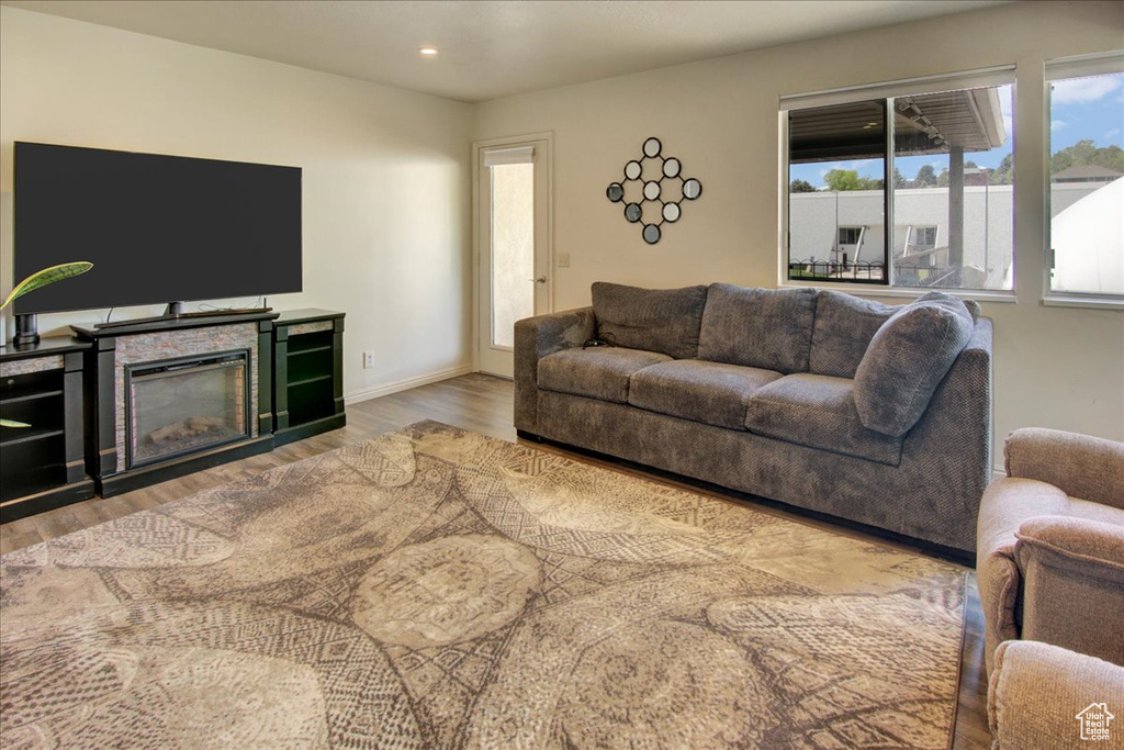 Living area with wood finished floors, recessed lighting, and baseboards