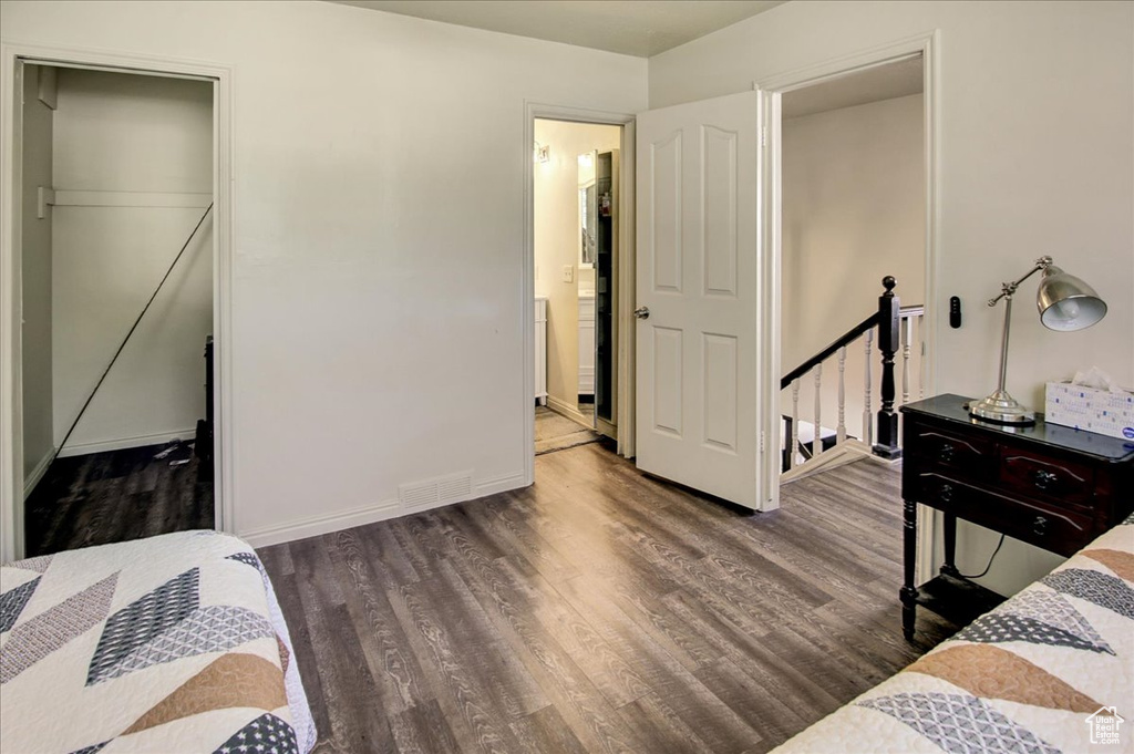 Bedroom with wood finished floors and baseboards