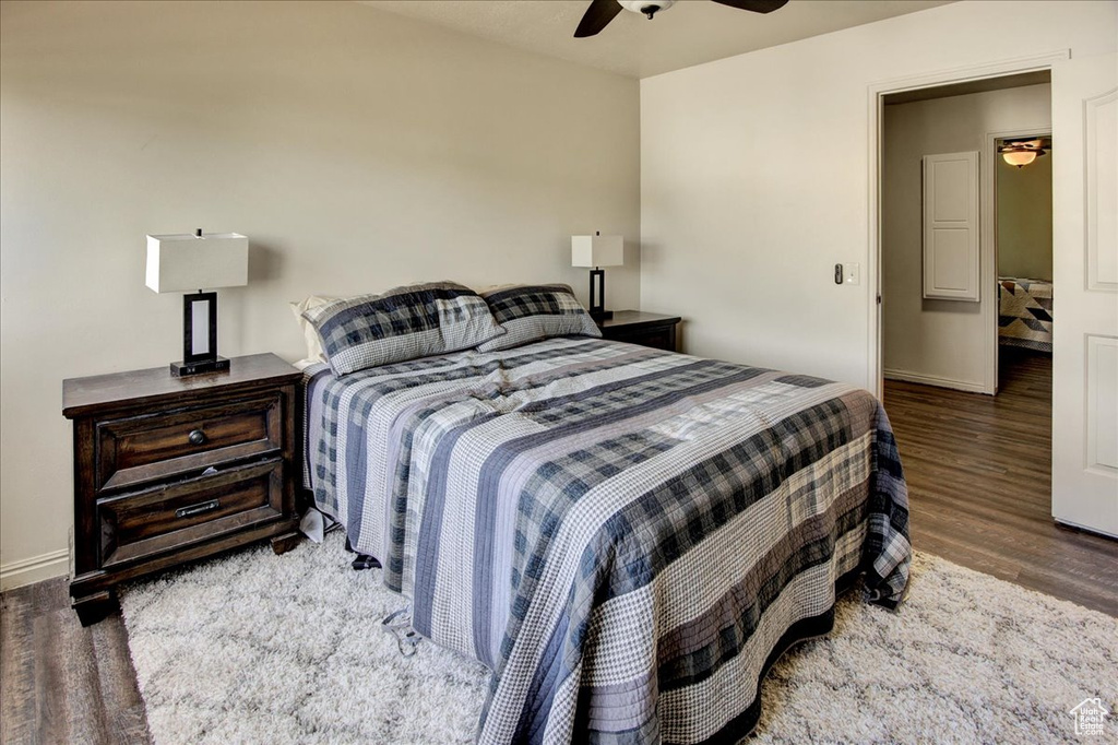 Bedroom with wood finished floors, baseboards, and a ceiling fan