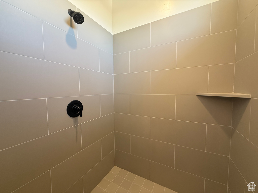 Full bath featuring tiled shower